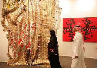 Visitors check out art displayed at Art Dubai in 2011, which has become a leading contemporary art fair for collectors artist and professionals from the Middle East,