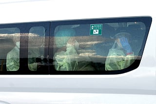 A bus carrying passengers caught up in the MV Hondius hantavirus outbreak, arrives at a purpose-built quarantine facility located on the outskirts of the Western Australian city of Perth on May 15, 2026.