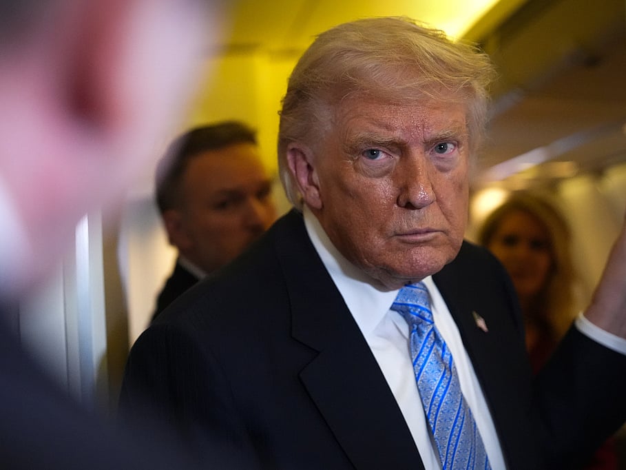 President Donald Trump speaks to reporters aboard Air Force One, Friday, May 15, 2026, as he returns from a trip to Beijing, China.