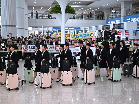 39 North Korean players and staff were greeted by supporters holding welcome signs upon arrival at the airport. 