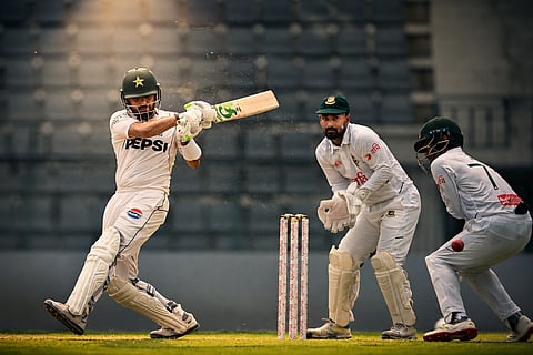 Pakistan’s Babar Azam (L) plays a shot as Bangladesh’s wicketkeeper Litton Das (C) and Mominul Haque field the ball during the second day of the second Test cricket match between Bangladesh and Pakistan at the Sylhet International Cricket Stadium