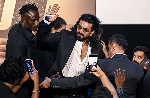 Indian actor Ram Charan (C) attends the trailer launch of his upcoming film 'Peddi' in Mumbai on May 18, 2026.