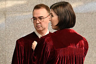 Philippine Senator Pia Cayetano (right), elder sister of former Senate President and chief judge Alan Cayetano, fixes the robes of her brother prior to taking their oath as jurors in the impeachment trial of Vice President Sara Duterte at the plenary hall of the Senate in Manila. File photo taken on May 18, 2026.