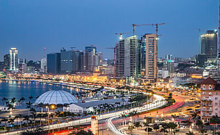 Luanda glows along the Atlantic shoreline as waves roll in under night skies, where cranes and rising towers signal rapid construction while the capital’s waterfront pulses with vibrant nightlife and sea-breeze energy.