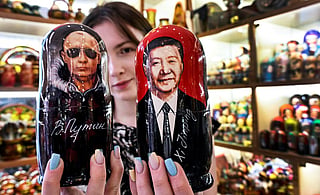 A vendor offers traditional Russian wooden nesting dolls, Matryoshka dolls, depicting Russian President Vladimir Putin and Chinese President Xi Jinping at a gift shop in downtown Moscow on May 19, 2026, as the Russian leader in on a visit to Beijing on May 19-20.