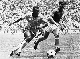 Brazilian midfielder Pele (L) dribbles past Italian defender Tarcisio Burgnich during the World Cup final on June 21, 1970 in Mexico City.