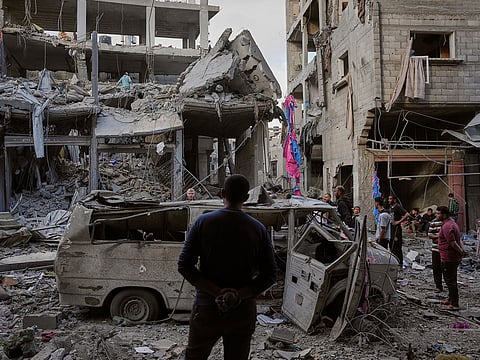 Palestinians inspect the rubble of the Ismail family home, destroyed in Israeli airstrike at Al Maghazi camp, in the central Gaza Strip.