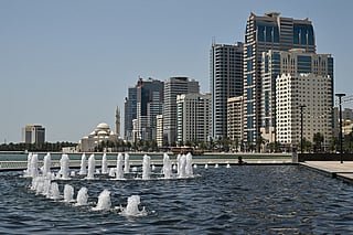 A photograph shows the Al-Nooor Mosque (L) and the city skyline in Sharjah in the United Arab Emirates on May 21, 2026.