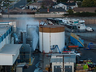 Water is sprayed on a tank that overheated at an aerospace plant in Garden Grove, Calif., Friday, May 22, 2026. (AP Photo/Ethan Swope)