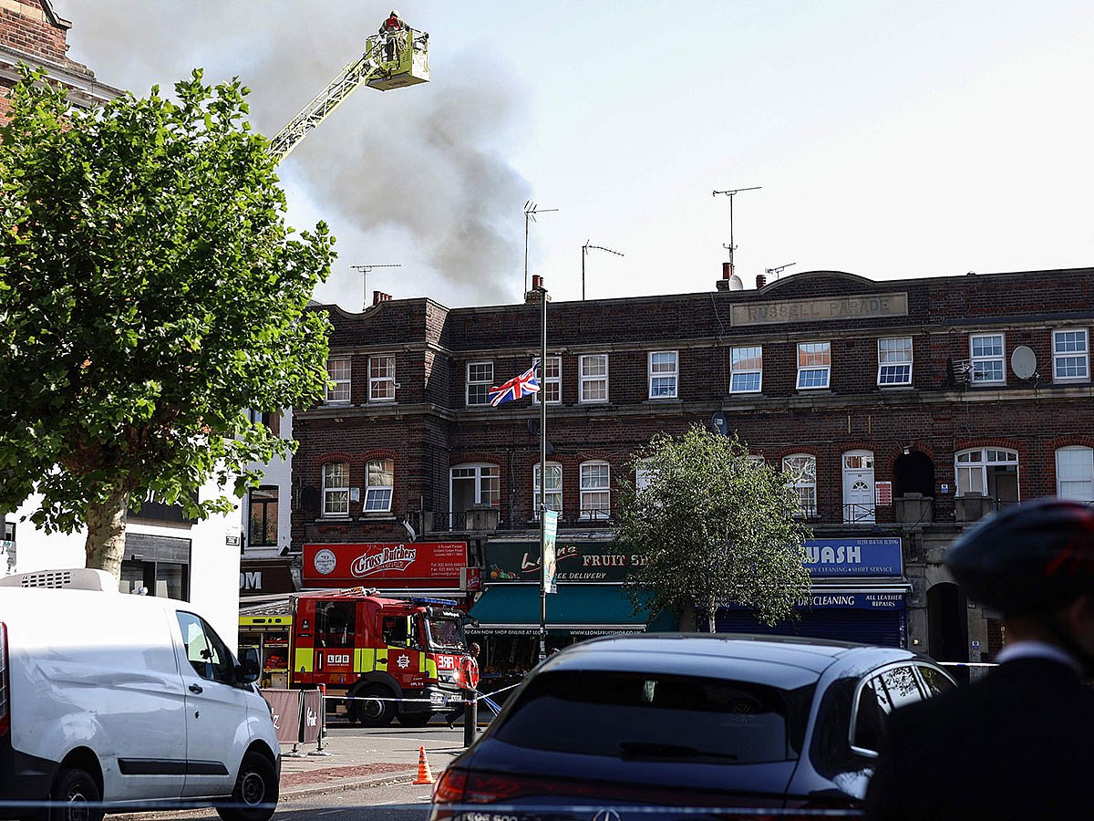 Emergency services work at the site of a fire which broke out at a supermarket in the Golders Green neighbourhood in north London.