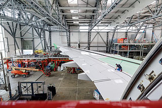 An employee of Elbe Flugzeugwerke GmbH works on a wing of a Lufthansa Airbus A380 airplane in Dresden, eastern Germany on May 27, 2026.