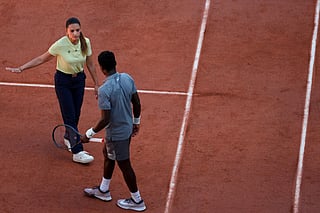 Brazilian chair umpire Ana Carvalho speaks to France's Moise Kouame as he plays against Paraguay's Adolfo Daniel Vallejo during their men's singles match on day 5 of the French Open tennis tournament on Court Suzanne-Lenglen at the Roland-Garros Complex in Paris on May 28, 2026.