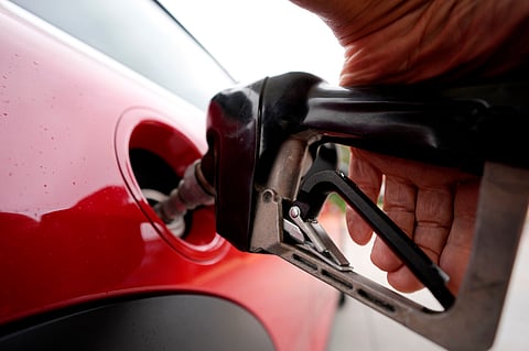 A motorist pumps fuel at a station.