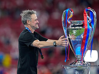 PSG's head coach Luis Enrique walks towards the trophy at the end of the Champions League final soccer match between Paris Saint-Germain and Arsenal in Budapest, Hungary.