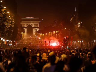 PSG supporters gather on the Champs-Elysees Avenue after the club won the UEFA Champions League final between Paris Saint-Germain (PSG) and Arsenal FC played in Budapest, in Paris.