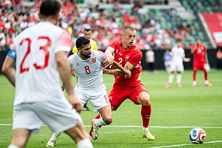 Jordan's midfielder #8 Noor Al Rawabdeh (C) fights for the ball with Switzerland's defender #2 Miro Muheim (R) during a friendly match between Switzerland and Jordan ahead of the 2026 FIFA World Cup football tournament at the Kybunpark stadium, in St. Gallen on May 31, 2026.