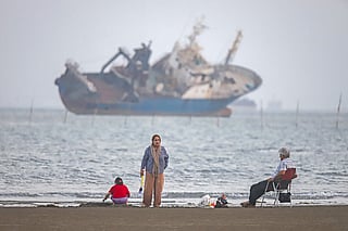 In this picture obtained from Iran's ISNA news agency on June 1, 2026, Iranians sit on Suru Beach in Bandar Abbas along the Strait of Hormuz.