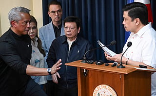 Philippines' Interior Secretary Jonvic Remulla (left) gestures to Philippine Senator Jose "Jinggoy" Estrada (right) after a press conference as Estrada's colleagues, Senators Imee Marcos (2nd L), Senate President Alan Cayetano (C), and Rodante Marcoleta (2nd from right) look on, after a warrant of arrest was served at the Senate building in Manila on June 1, 2026.