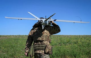 A Ukrainian soldier carries a drones. Cross-border drone attacks have intensified in recent months as Russia and Ukraine continue to trade strikes in the more than four-year war.