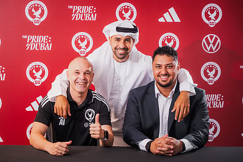 Former Spain and Barcelona star Andres Iniesta is welcomed by Gulf United president Ahmed El Saraf and director of football following his appointment as head coach in Dubai.
