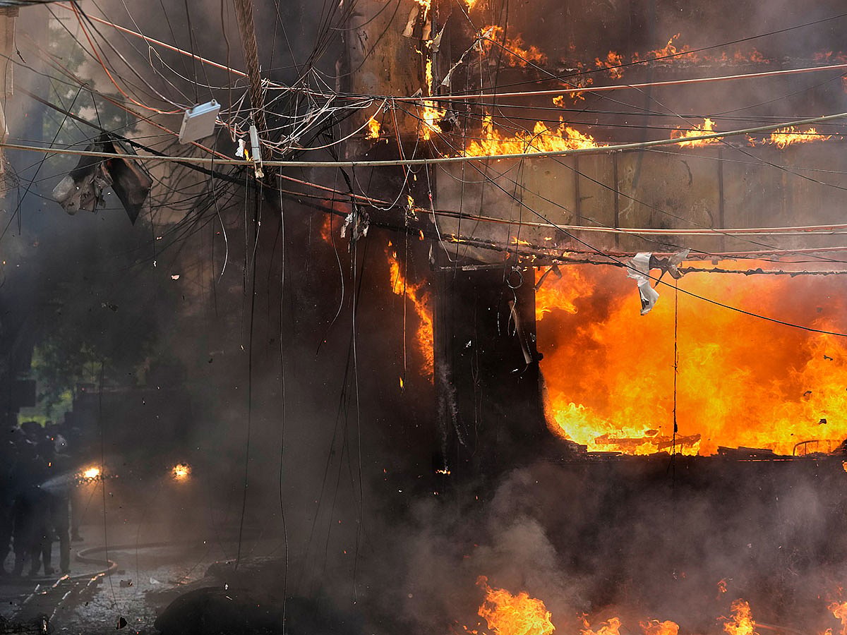 Fire officials douse a fire at a hotel in New Delhi, India