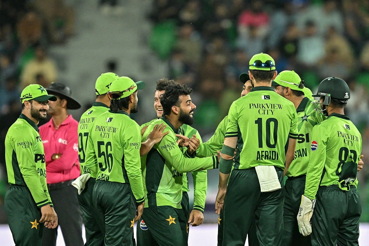 Pakistan's Shadab Khan (C) celebrates with teammates after taking the wicket of Australia's Oliver Peake during the third one-day international (ODI) cricket match between Australia and Pakistan at Gaddafi Stadium in Lahore on June 4, 2026.