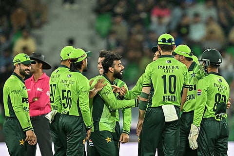Pakistan's Shadab Khan (C) celebrates with teammates after taking the wicket of Australia's Oliver Peake during the third one-day international (ODI) cricket match between Australia and Pakistan at Gaddafi Stadium in Lahore on June 4, 2026.