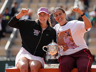 Russia's Mirra Andreeva, left, and her coach Conchita Martinez pose with the trophy after winning the final women's tennis match against Poland's Maja Chwalinska at the French Open in Paris.