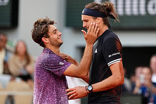 Winner Germany's Alexander Zverev cheers Italy's Flavio Cobolli at the end of their men's final singles match on day 15 of the French Open tennis tournament on Court Philippe-Chatrier at the Roland-Garros Complex in Paris on June 7, 2026.