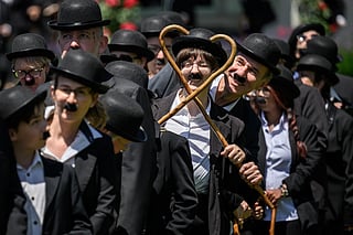 Some 429 people dressed as 'The Tramp' gather for a photograph in front of The Manoir de Ban, the final residence of English film director and actor Charlie Chaplin, during an event to celebrate the 10th anniversary of the Chaplin's World museum in Corsier-sur-Vevey, western Switzerland.