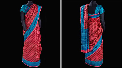 Inside the Smithsonian National Air and Space Museum in Washington DC, between objects that have touched the edges of human possibility, there is a red and blue silk sari. 