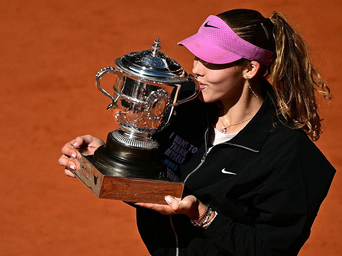 Russia's Mirra Andreeva kisses the trophy after winning the French Open tennis tournament women's singles final match against Poland's Maja Chwalinska on day 14 of the French Open tennis tournament on Court Philippe-Chatrier at the Roland-Garros Complex in Paris.