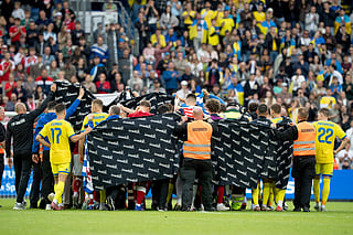 Denmark's and Ukraine's players accompany Christian Eriksen to a waiting ambulance during the international friendly soccer match between Denmark and Ukraine in Odense, Denmark, Sunday, June 7, 2026, after Eriksen has collapsed on the field again while playing for Denmark’s national team. (Bo Amstrup/Ritzau Scanpix via AP)