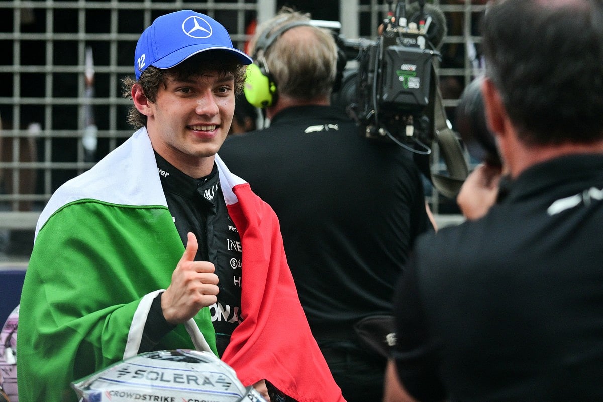 Winner Mercedes' Italian driver Kimi Antonelli wrapped in the national Italian flag celebrates after competing in the Monaco Formula 1 Grand Prix at the Monaco street circuit in Monaco, ahead of the, on June 7, 2026.