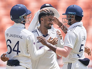 India's Manav Suthar, centre, is congratulated by teammates after taking his fifth wicket of the innings on day three of the Test match against Afghanistan in New Chandigarh, on Monday, June 8, 2026. 