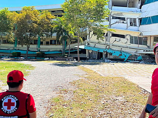 Philippine Red Cross, rescuers inspect the damage to Notre Dame of Dadiangas University after an earthquake in General Santos.
