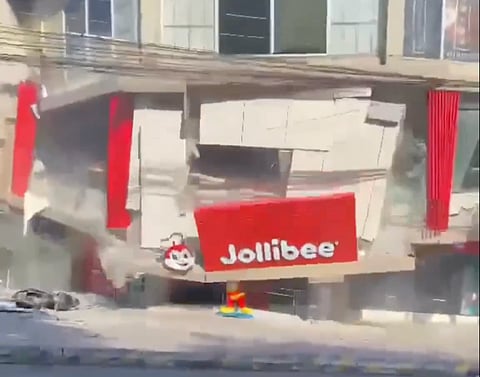 A screengrab of a video shows a building housing  a Jollibee fastfood store collapsing following a strong quake in Mindanao, southern Philippines.