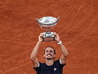 Germany's Alexander Zverev lifts "La Coupe des Mousquetaires" trophy after winning the men's final singles match against Italy's Flavio Cobolli on day 15 of the French Open tennis tournament on Court Philippe-Chatrier at the Roland-Garros Complex in Paris.