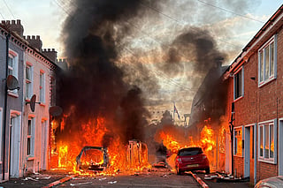 Vehicles set on fire by protesters burn on Lendrick Street in east Belfast, Northern Ireland, on Tuesday, June 9, 2026, after the arrest of a Sudanese man accused of stabbing a man in the northern part of the city. 