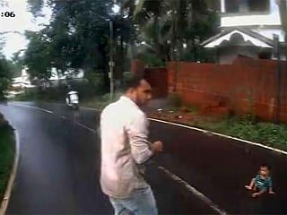 A dramatic moment as conductor Navas runs to rescue an infant spotted crawling on the Kondotty-Valiyaparamba road in Kerala.