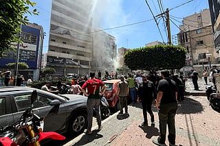 People gather at the site of an Israeli airstrike that targeted a building in Beirut’s southern suburbs on June 14, 2026.