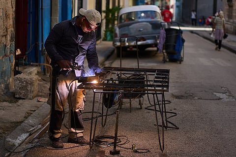 A man welds a door in Havana, Cuba, Tuesday, June 9, 2026.