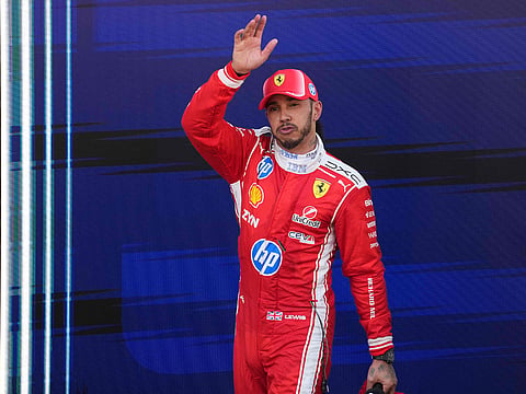 Ferrari's British driver Lewis Hamilton celebrates after winning the Catalonia Formula One Grand Prix at the Circuit de Catalunya in Montmelo, on the outskirts of Barcelona.