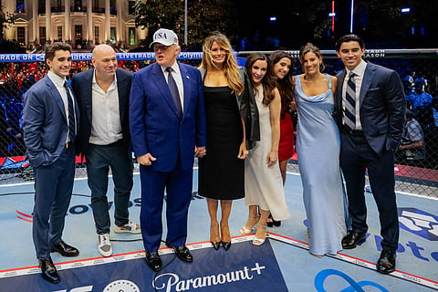 President Donald Trump, first lady Melania Trump, UFC CEO Dana White and other guests pose inside the Octagon at UFC Freedom 250 on the South Lawn of the White House on June 15, 2026 in Washington, DC. 