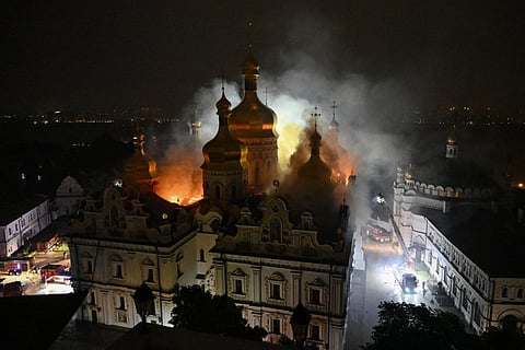 Smoke and fire rises from the Dormition Cathedral in the Orthodox complex of the Kyiv Pechersk Lavra following a missile strike on the Ukrainian capital Kyiv on June 15, 2026.