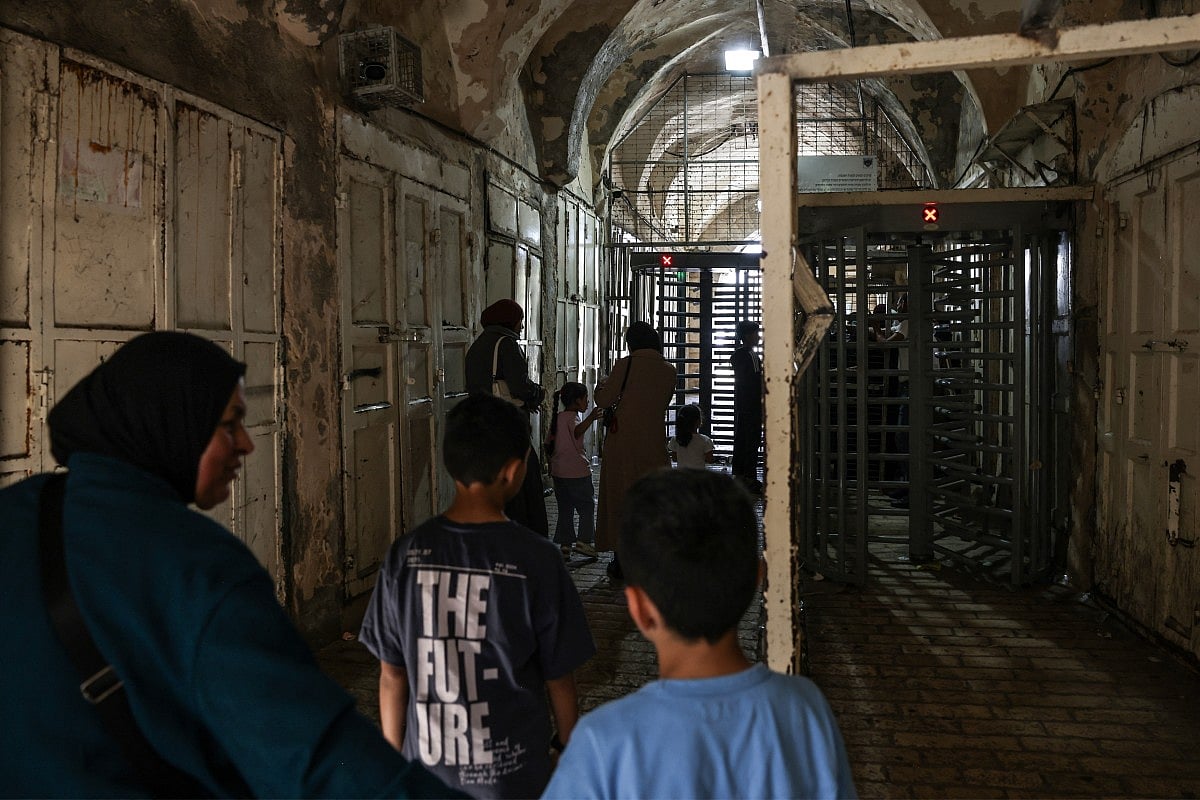Palestinians make their way through an Israeli checkpoint to attend celebrations of the Islamic Hijri New Year at the Ibrahimi Mosque, known to Jews as the Cave of the Patriarchs, located inside the Israeli-controlled H2 sector of the occupied West Bank city of Hebron, on June 16, 2026.