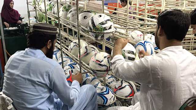Staff inspecting the World Cup balls in 2022