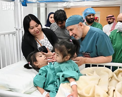 Dr Abdullah Al Rabeeah (right) and Ginalyn Manuel with Olivia and Gianna before the surgery.