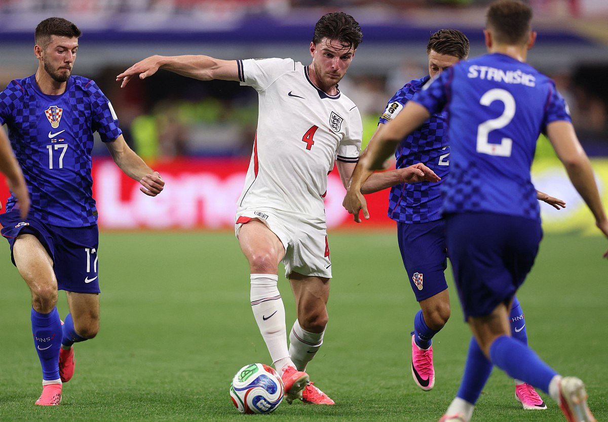 Declan Rice #4 of England is challenged by Petar Sucic #17 and Marco Pasalic #24 of Croatia during the FIFA World Cup 2026 Group L match between England and Croatia at Dallas Stadium on June 17, 2026 in Dallas, Texas.