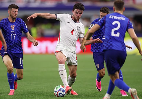 Declan Rice #4 of England is challenged by Petar Sucic #17 and Marco Pasalic #24 of Croatia during the FIFA World Cup 2026 Group L match between England and Croatia at Dallas Stadium on June 17, 2026 in Dallas, Texas.
